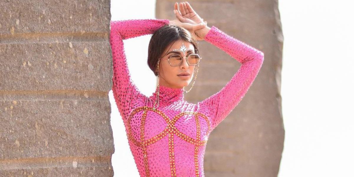 A woman at mardi gras wearing a mardi gras outift from born in stockholm