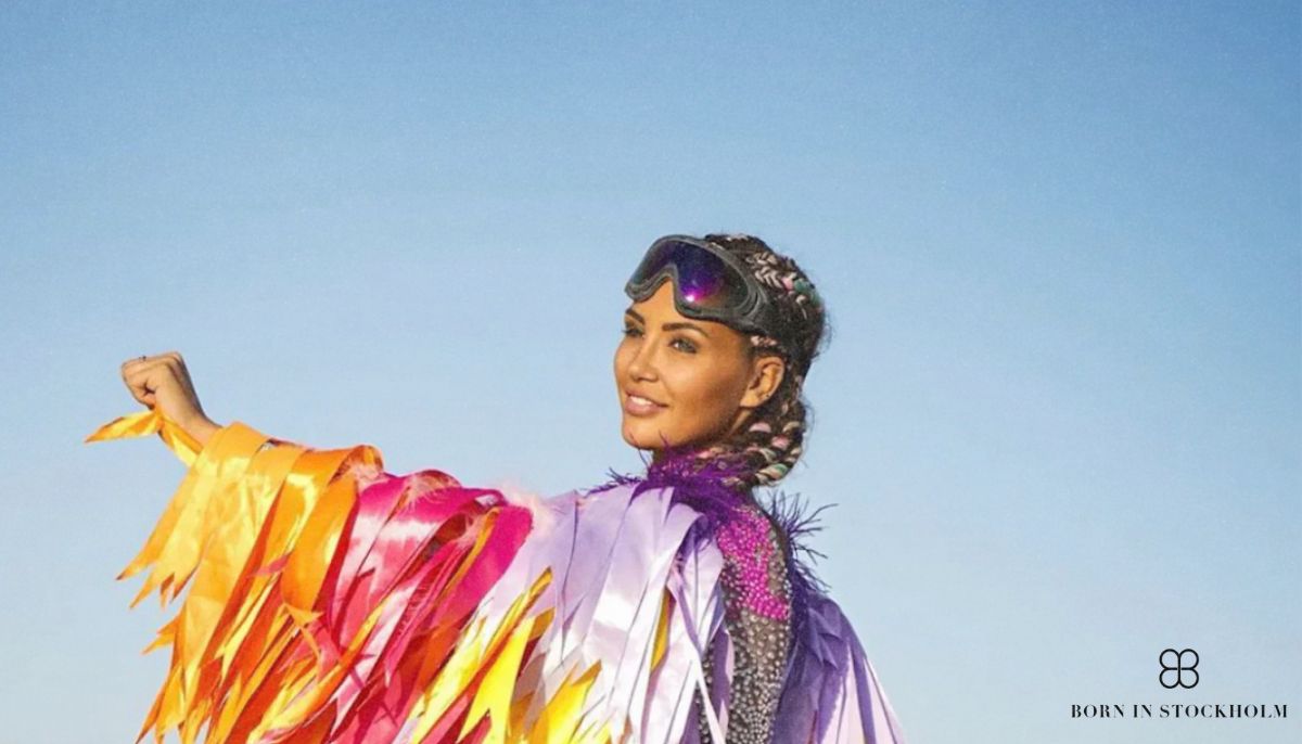 a woman wearing a born in stockholm costume at burning man